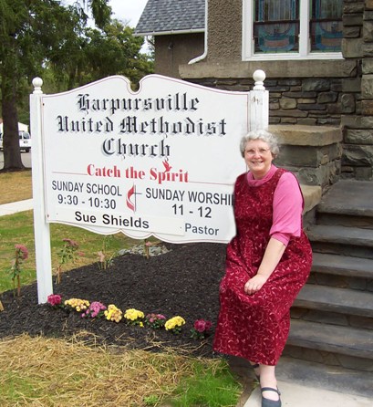 Photo of Linda Bonney Olin sitting on steps of Harpursville United Methodist Church