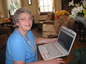 Photo of Linda Bonney Olin working on her laptop computer at 2012 Montrose Christian Writers Conference