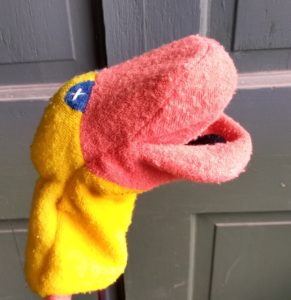 A soft, stretchy hand puppet in the shape of a yellow duck